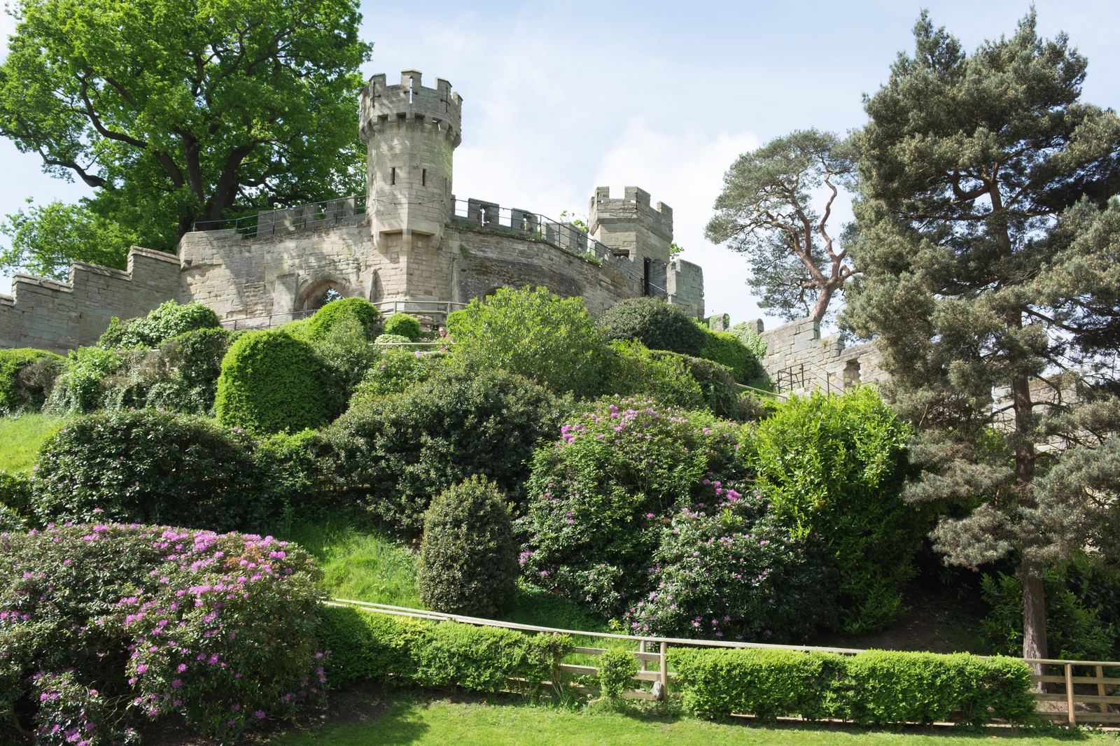 Warwick Castle towers rising above the trees on a spring day